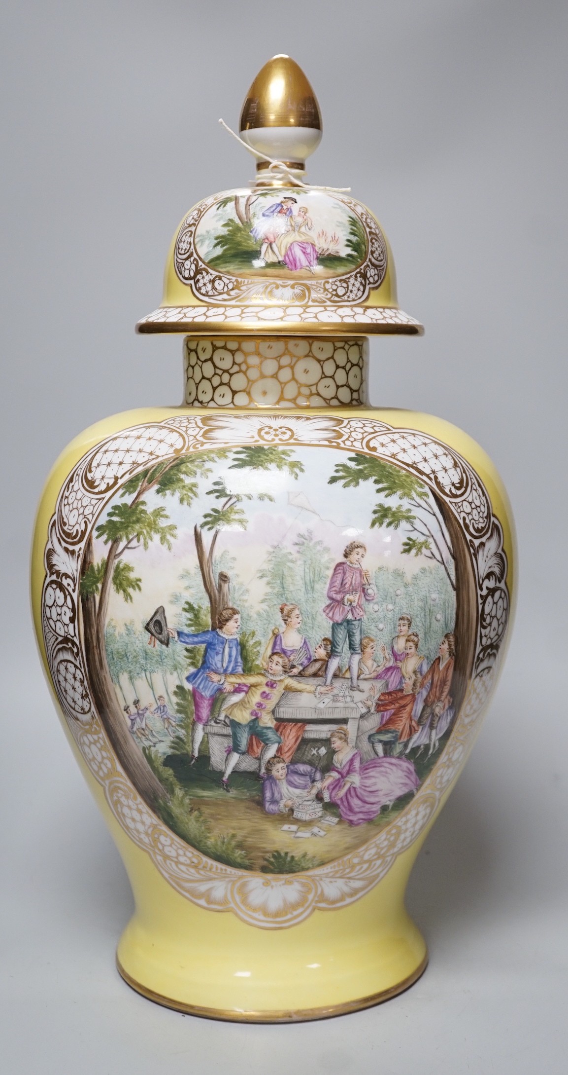 A large Helena Wolfsohn, Dresden vase and cover, from 1880, with a painted figural fishing cartouche one side and leisure activities the other, 52cms high